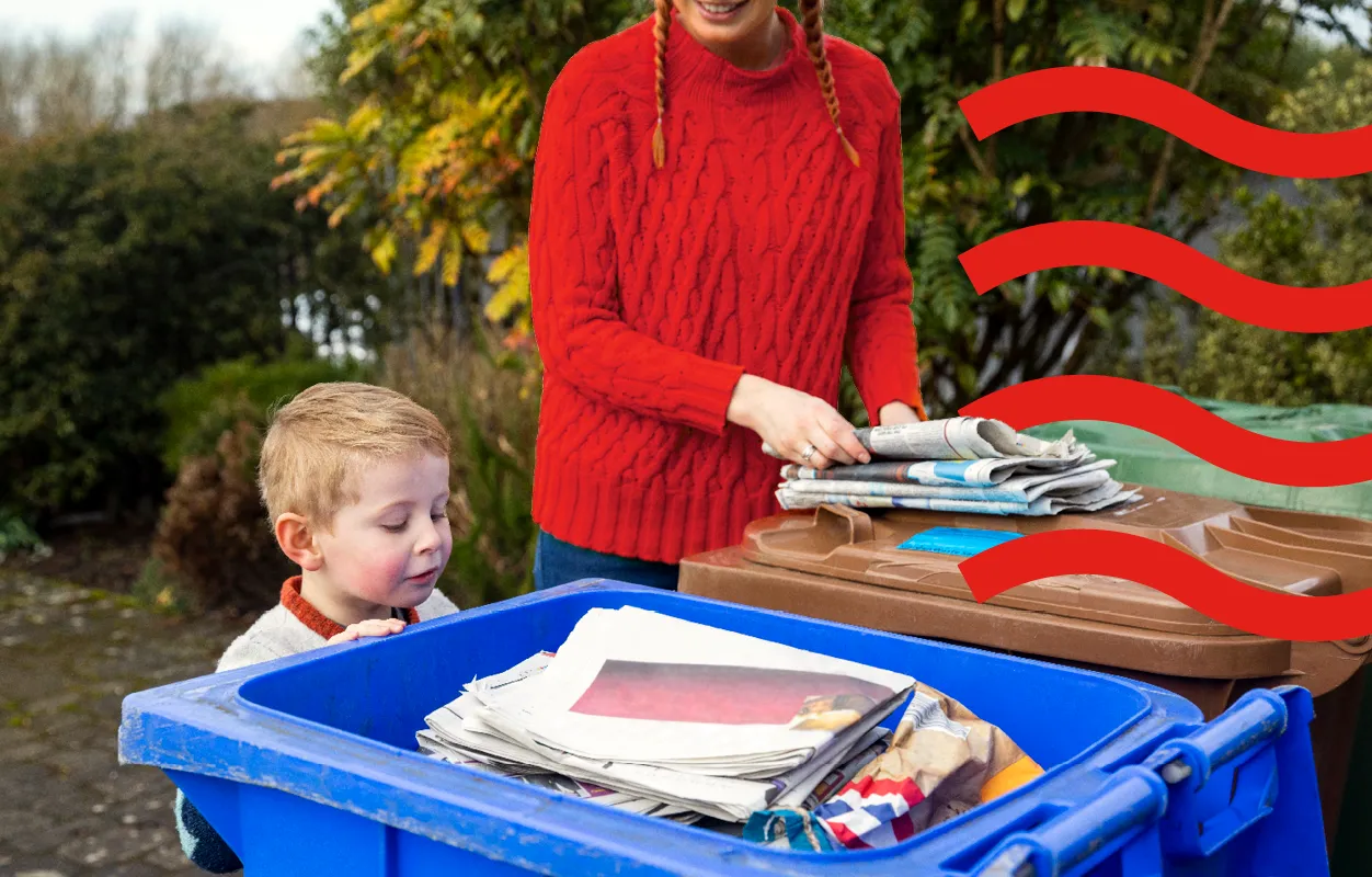 Family putting newspapers in recycling bins