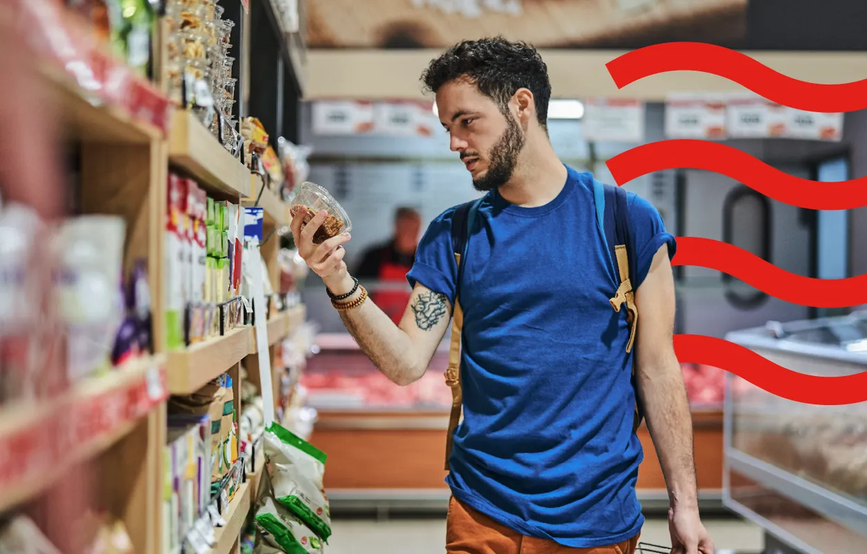 Man looking at product in supermarket