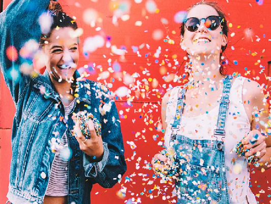 Two people throwing confetti