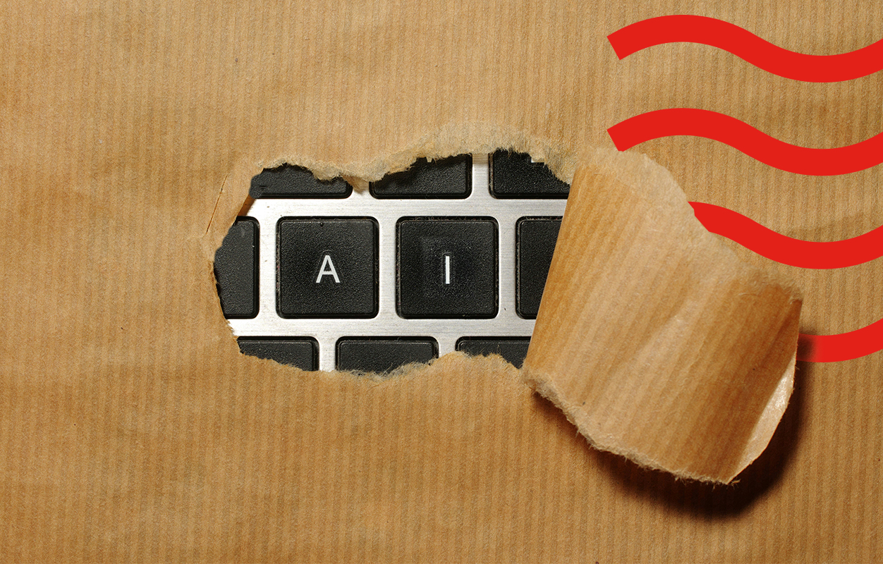 A torn piece of brown paper revealing a keyboard with the letters A and I