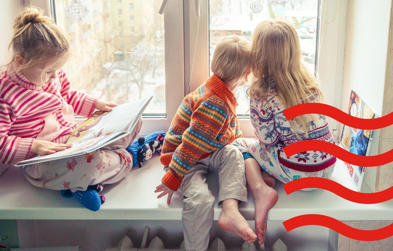 Kids seating in front of a window