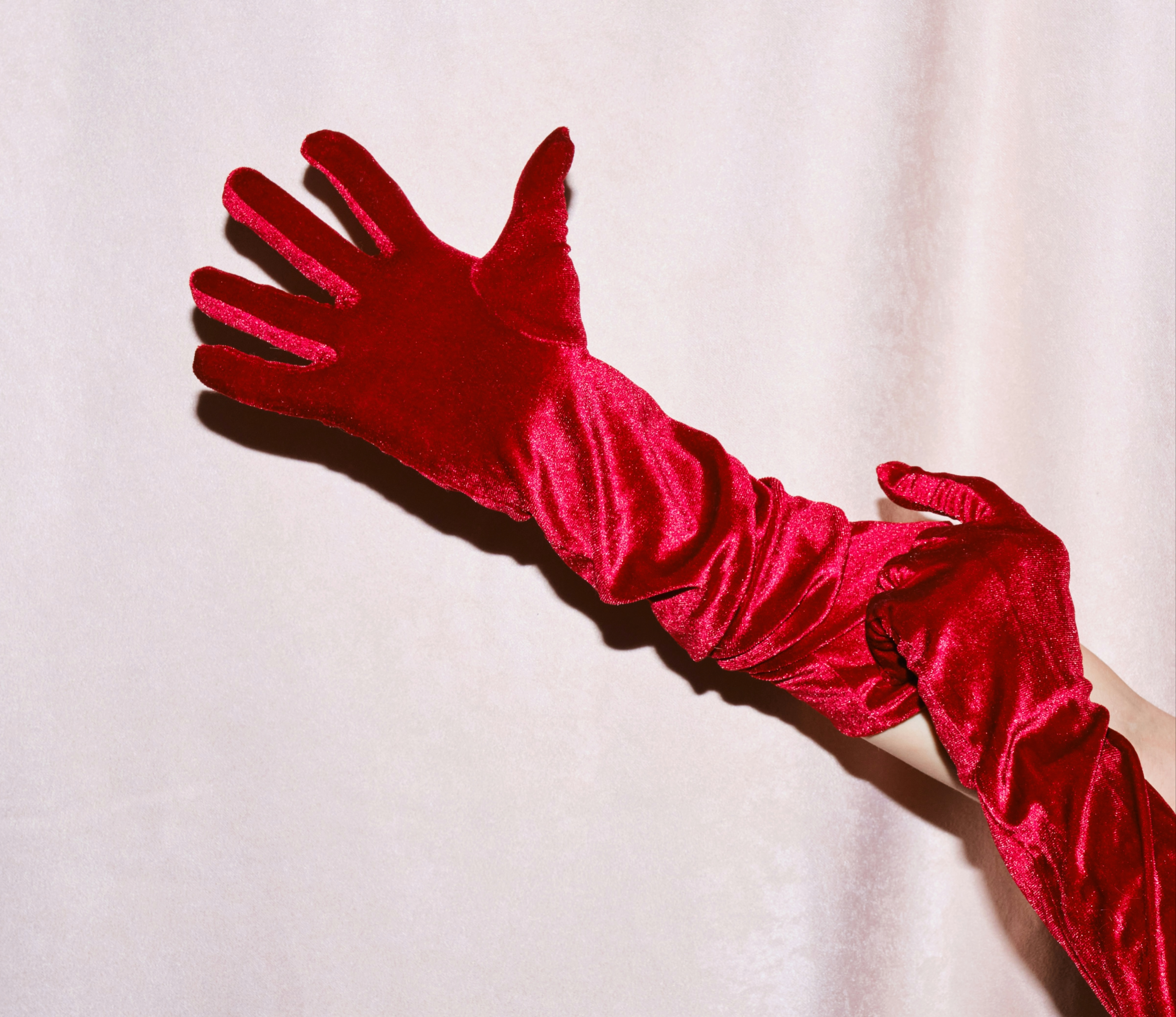 Red silk long glove on a hand