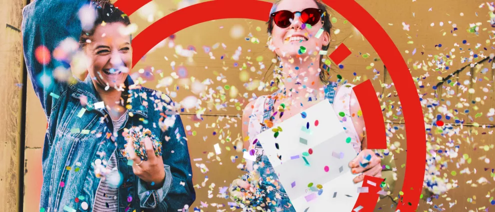 two ladies celebrating with confetti