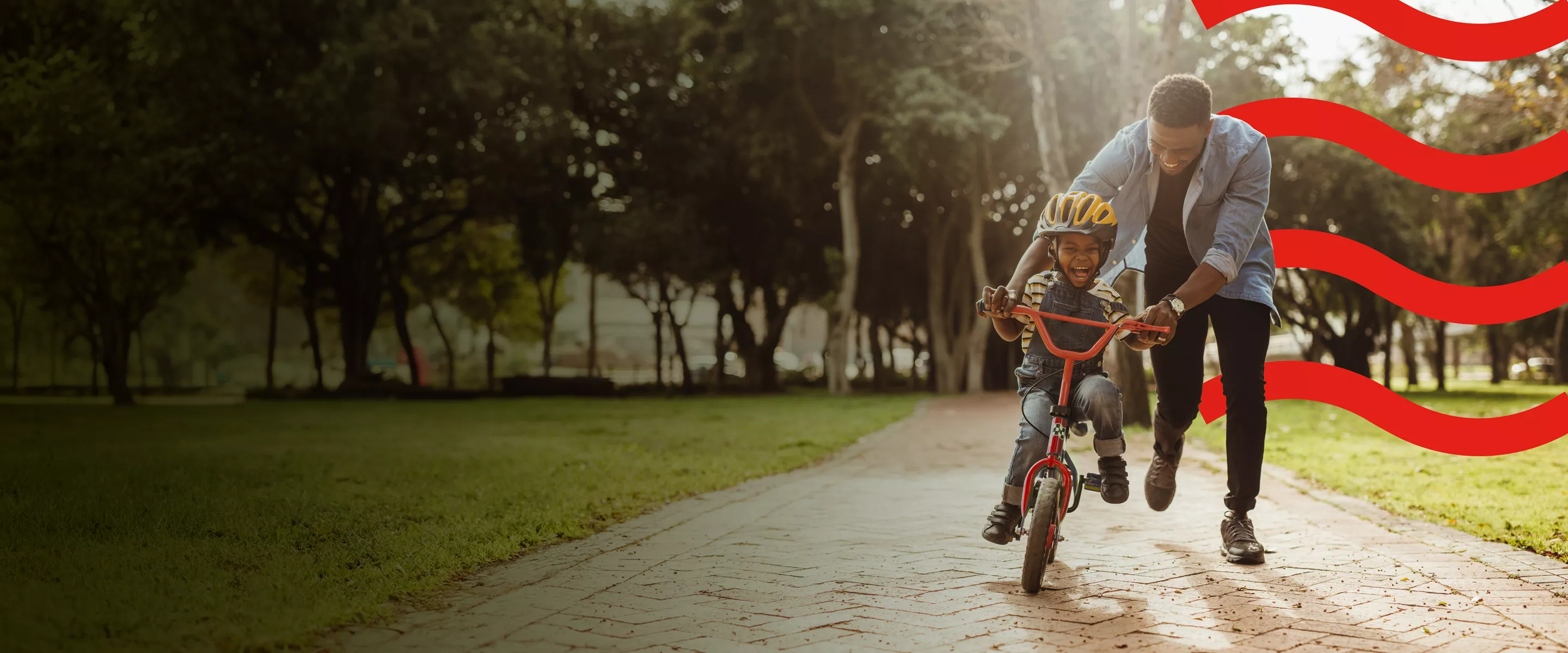 man teaching boy to ride a bike