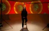 lady sitting in filming studio with projections