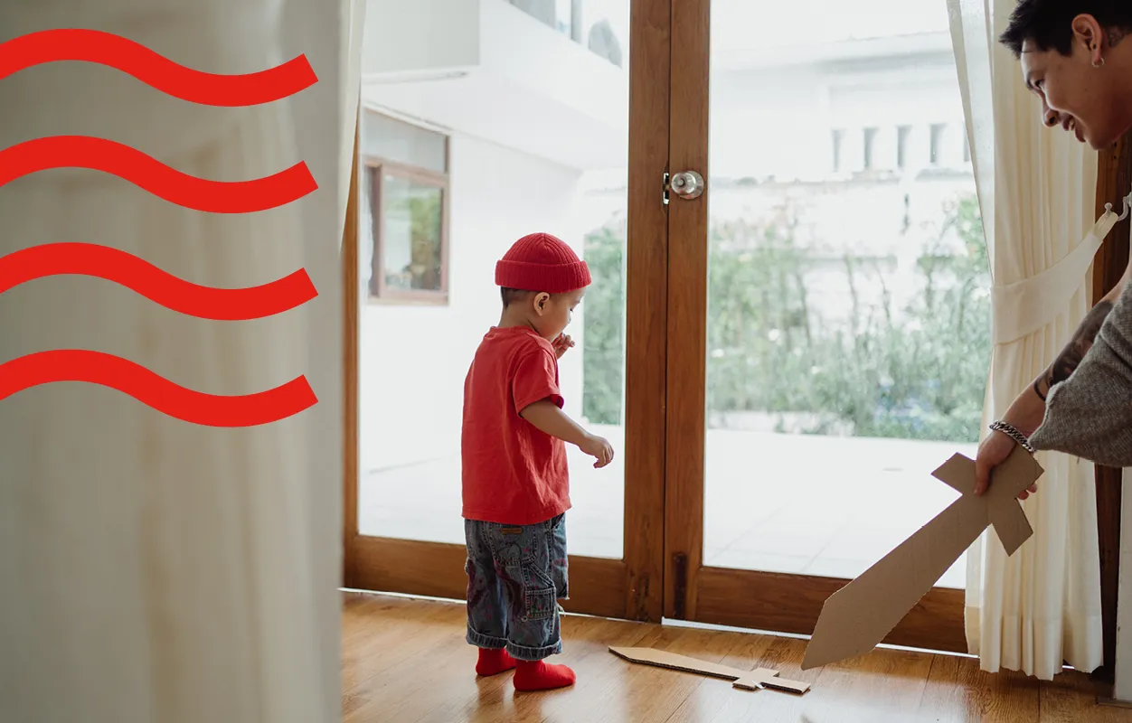 A kid playing with a wooden sword