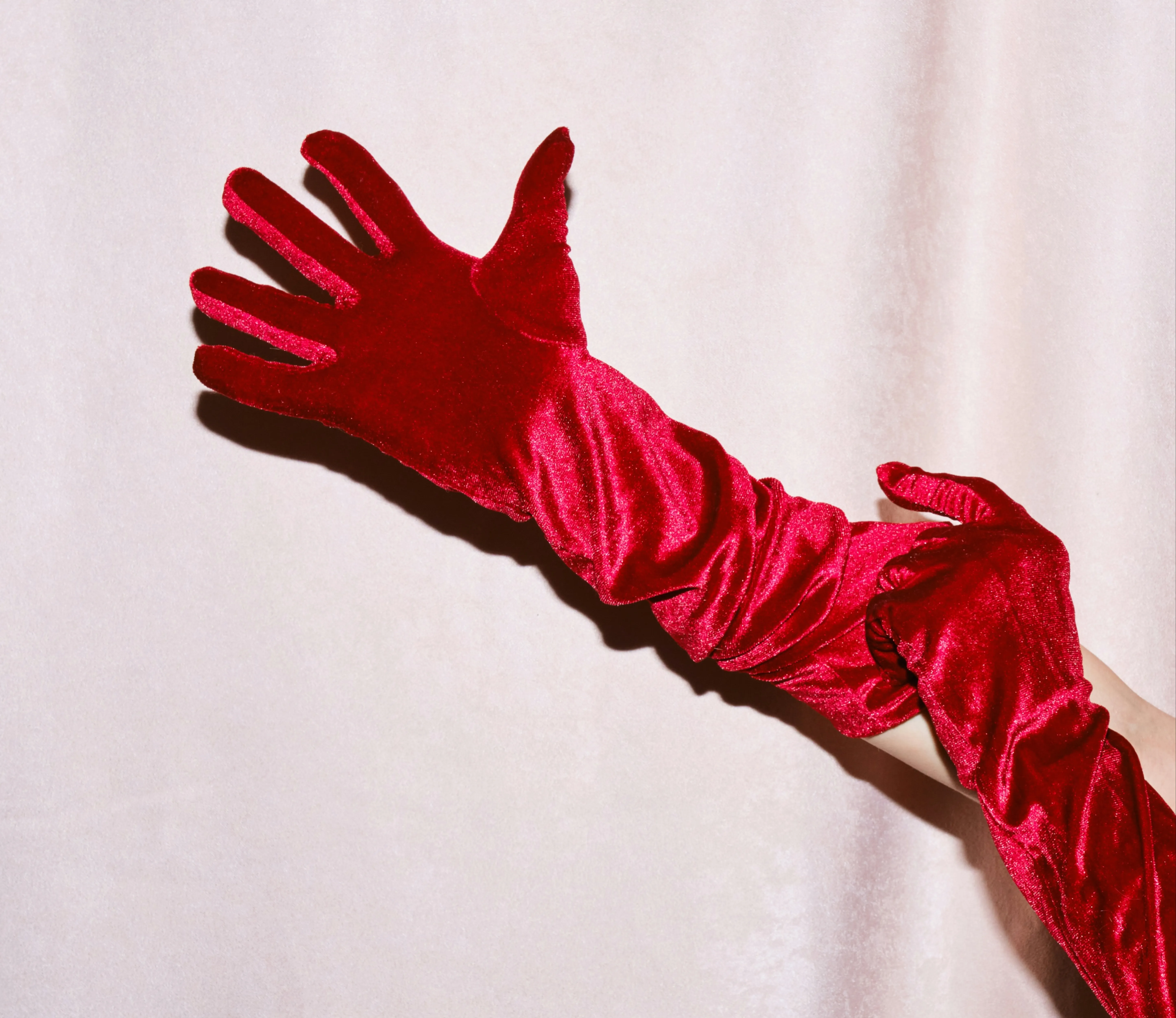 Red silk long glove on a hand