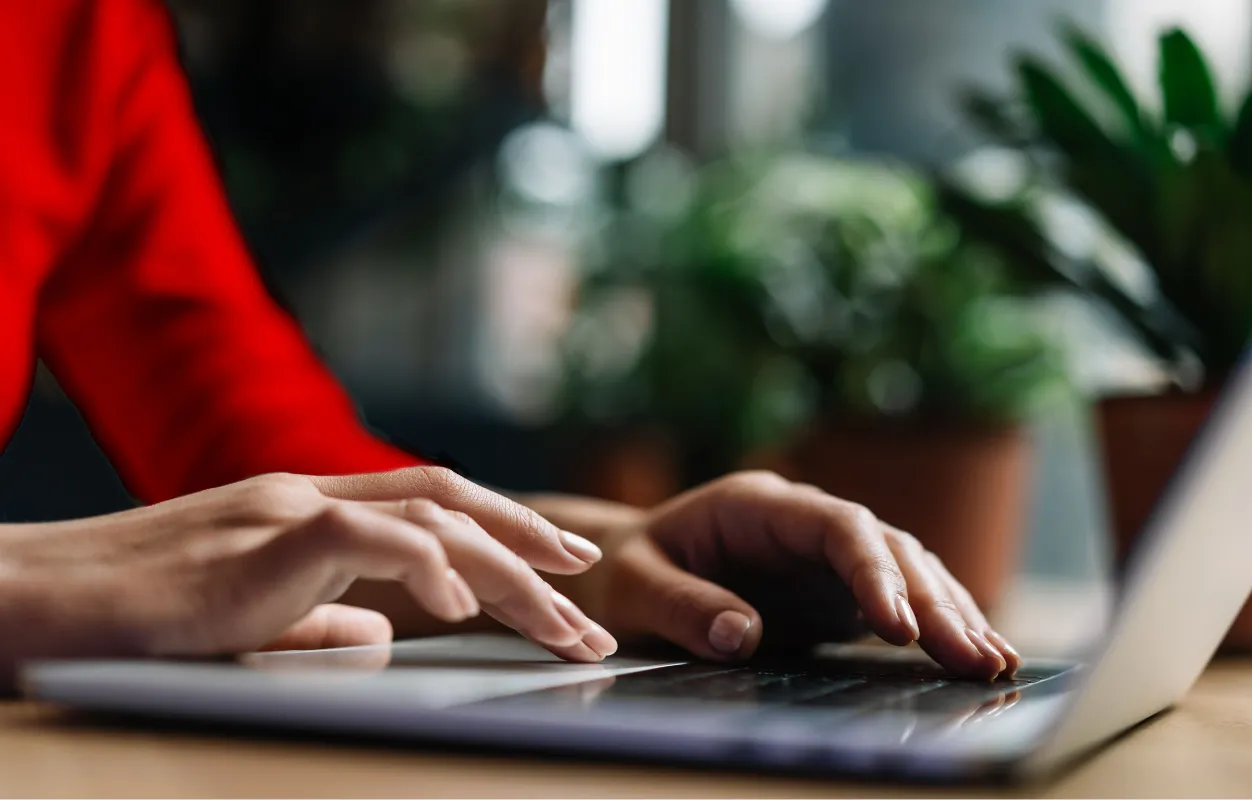 Woman typing on a laptop