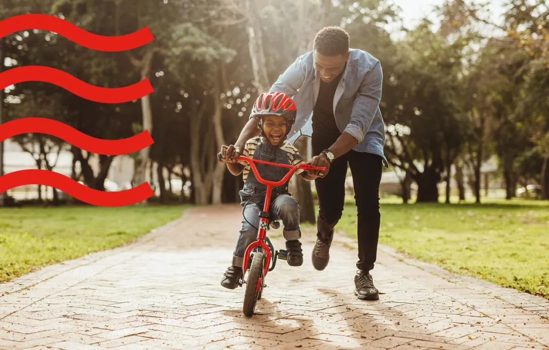 A dad with his son learning how to bike