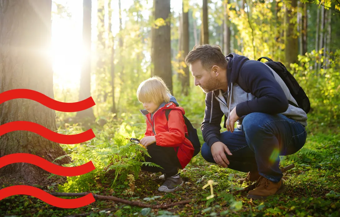 A man with his kid in the forest